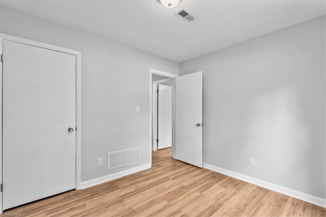 4 Manard Ct, Greensboro, NC 27407 - unfurnished bedroom with baseboards and light wood-style floors