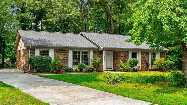4 Manard Ct, Greensboro, NC 27407 - ranch-style home with brick siding, a front lawn, and a shingled roof