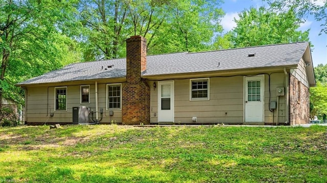 4 Manard Ct, Greensboro, NC 27407 - rear view of property with a chimney, cooling unit, a yard, and roof with shingles