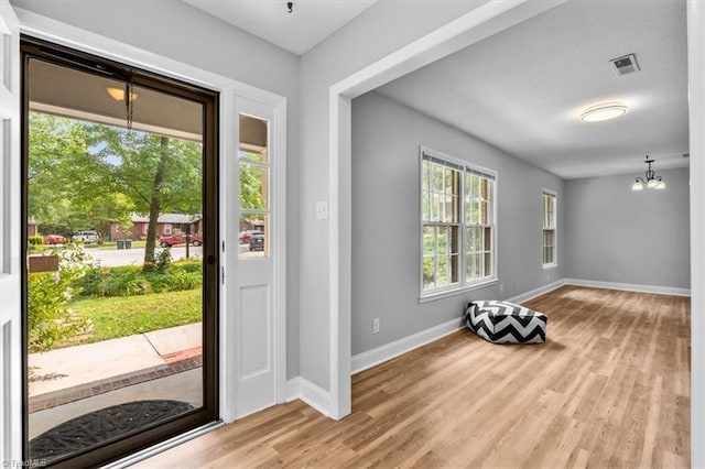 4 Manard Ct, Greensboro, NC 27407 - foyer featuring a chandelier, wood finished floors, and baseboards