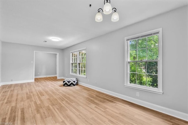 4 Manard Ct, Greensboro, NC 27407 - empty room featuring healthy amount of natural light, baseboards, and light wood-style floors