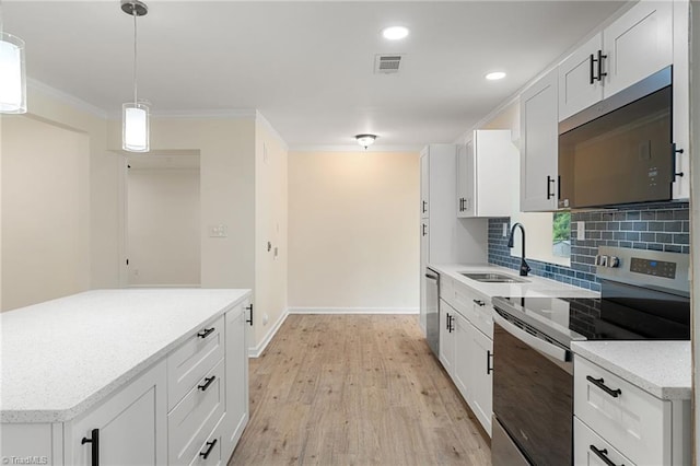 kitchen featuring a sink, tasteful backsplash, visible vents, ornamental molding, and appliances with stainless steel finishes