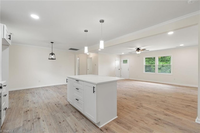 kitchen featuring light countertops, a ceiling fan, white cabinetry, and light wood-style floors