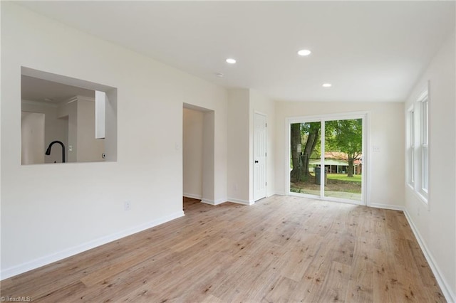 interior space featuring recessed lighting, wood finished floors, and baseboards