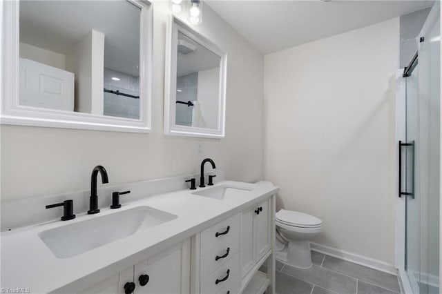 bathroom featuring toilet, a stall shower, tile patterned flooring, and a sink