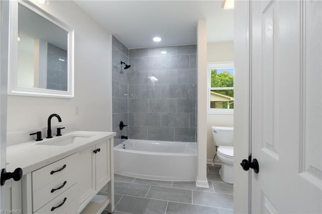 full bathroom featuring washtub / shower combination, baseboards, toilet, tile patterned floors, and vanity