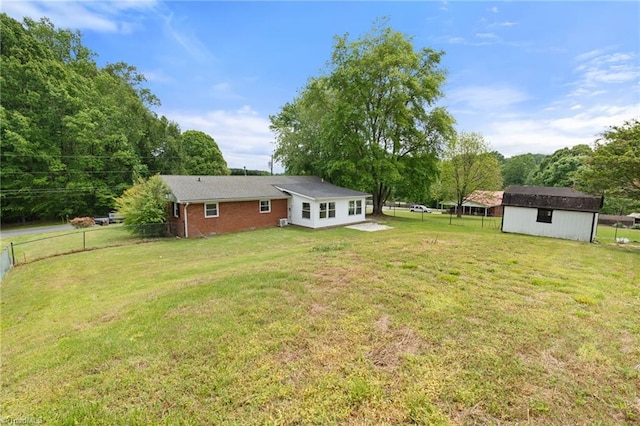 view of yard with an outdoor structure, a shed, and a fenced backyard