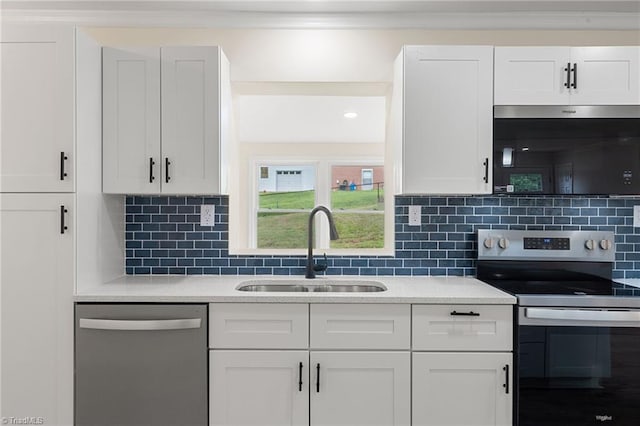 kitchen with a sink, white cabinets, appliances with stainless steel finishes, and light countertops