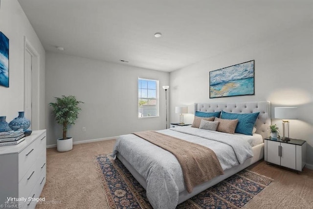 bedroom featuring baseboards and light colored carpet