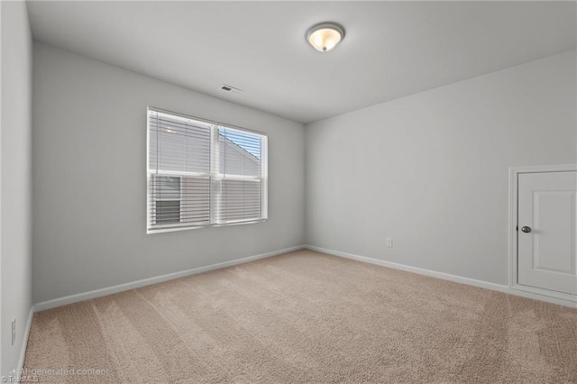 empty room with baseboards, carpet flooring, and visible vents