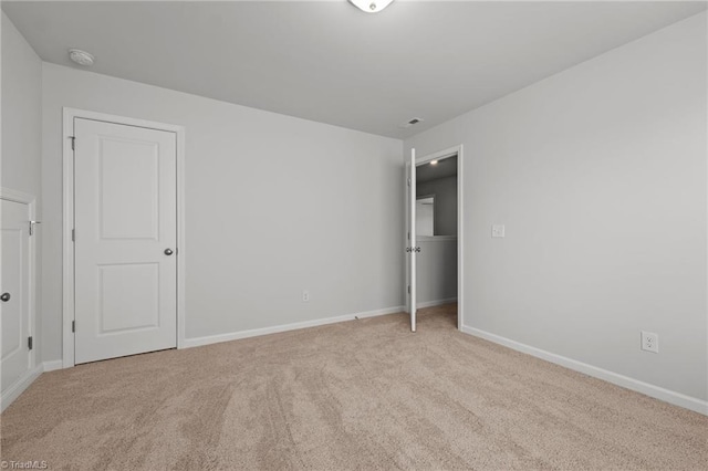 unfurnished bedroom with carpet floors and baseboards