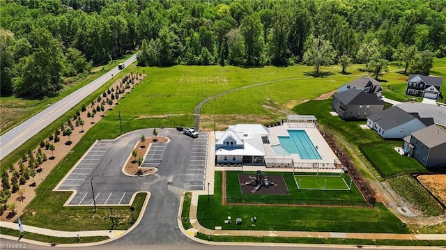 birds eye view of property featuring a view of trees