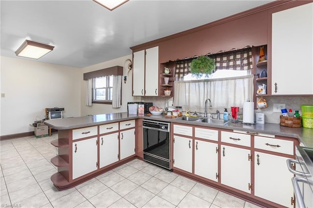 kitchen with tasteful backsplash, dishwasher, white cabinetry, and sink