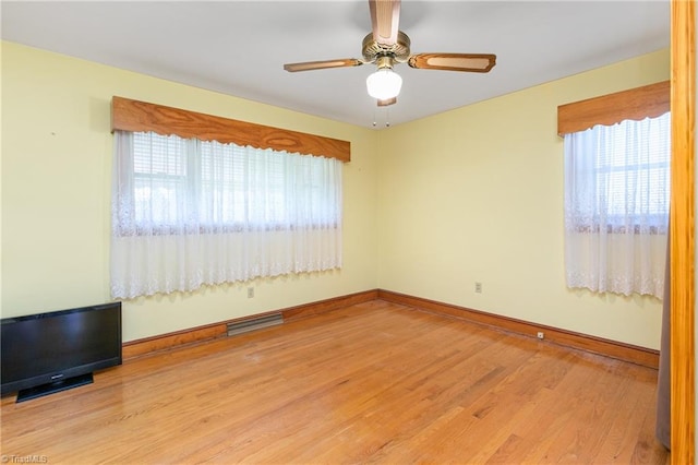 spare room with ceiling fan and light hardwood / wood-style floors