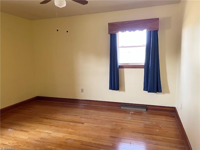 spare room with wood-type flooring and ceiling fan