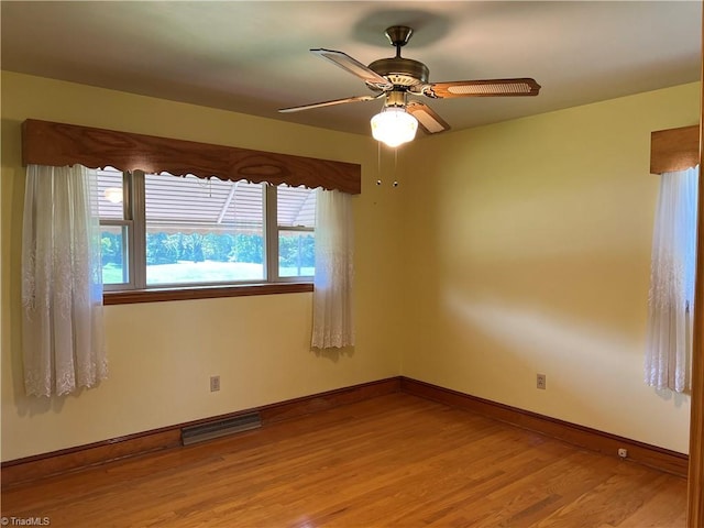 empty room featuring ceiling fan and wood-type flooring