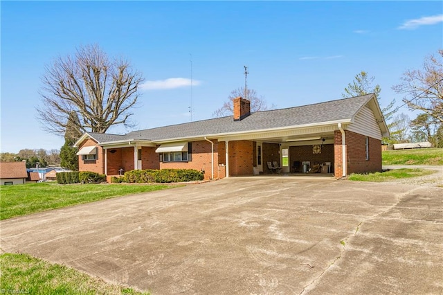 ranch-style house with a front lawn and a carport