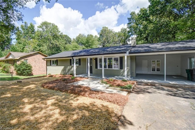 3422 Greenhill Dr, High Point, NC 27265 - ranch-style home with driveway, french doors, an attached carport, a chimney, and brick siding