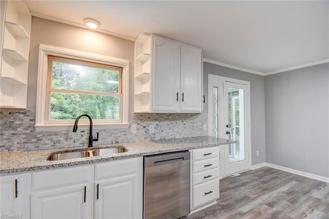 kitchen featuring dishwasher, light hardwood / wood-style floors, white cabinets, backsplash, and light stone countertops