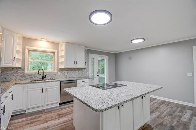 kitchen featuring white cabinetry, light wood-type flooring, a center island, stainless steel dishwasher, and sink