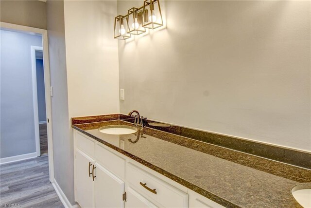 bathroom featuring hardwood / wood-style flooring and vanity