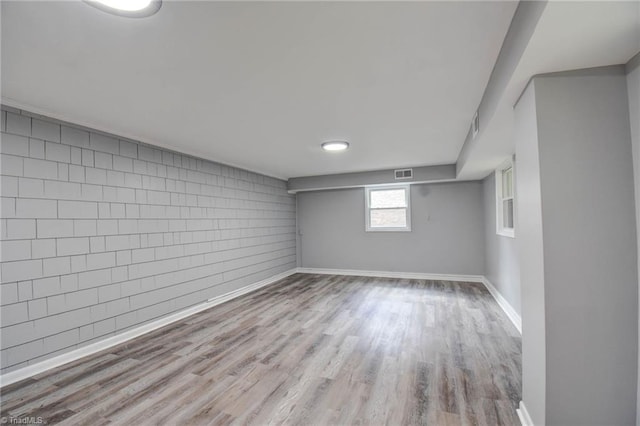 3422 Greenhill Dr, High Point, NC 27265 - below grade area with baseboards, visible vents, and wood finished floors