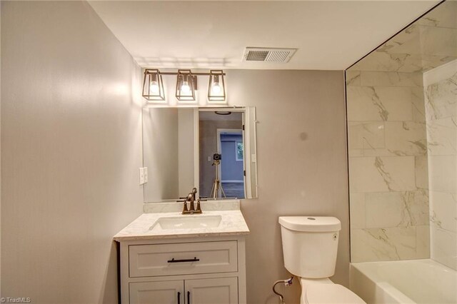 full bathroom featuring tiled shower / bath combo, vanity, and toilet