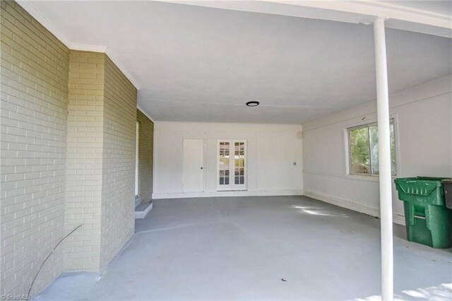 interior space featuring brick wall and concrete floors