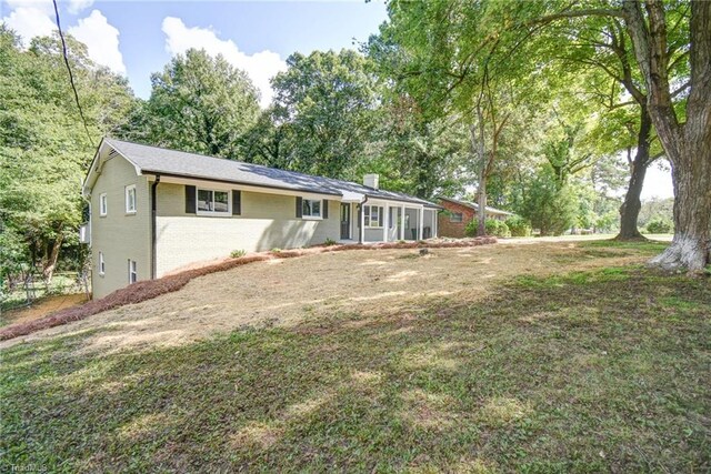 rear view of property with a lawn