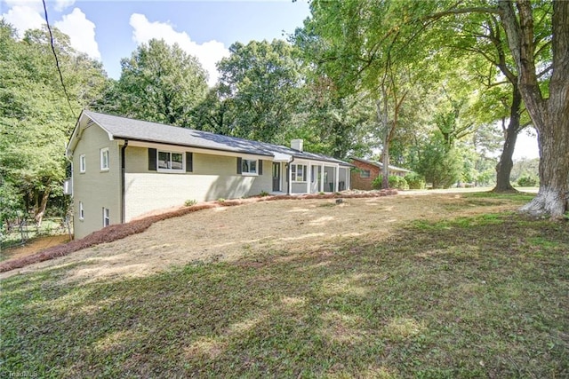 3422 Greenhill Dr, High Point, NC 27265 - rear view of property with a chimney, brick siding, and a lawn