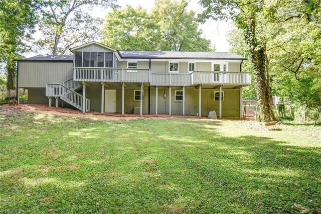 rear view of property featuring a sunroom and a yard