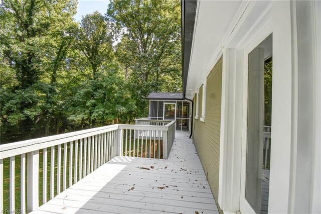 wooden terrace featuring a sunroom