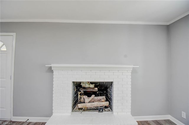 3422 Greenhill Dr, High Point, NC 27265 - room details featuring baseboards, wood finished floors, ornamental molding, and a brick fireplace