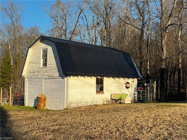 view of side of property with a yard and an outbuilding