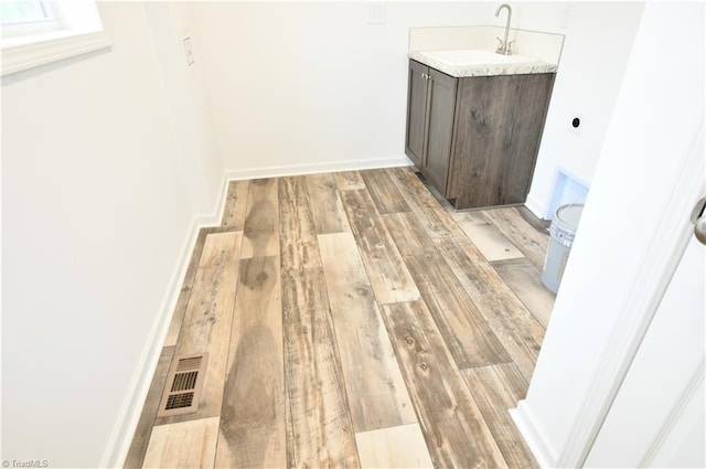 572 Kirby Bowman Rd, Siloam, NC 27047 - washroom featuring light wood finished floors, a sink, baseboards, and hookup for an electric dryer