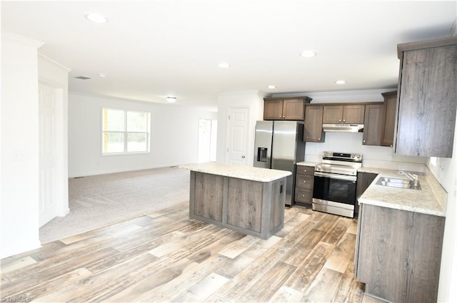 572 Kirby Bowman Rd, Siloam, NC 27047 - kitchen featuring stainless steel appliances, a sink, under cabinet range hood, a center island, and light countertops