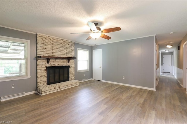 unfurnished living room featuring crown molding, a textured ceiling, wood finished floors, and a ceiling fan