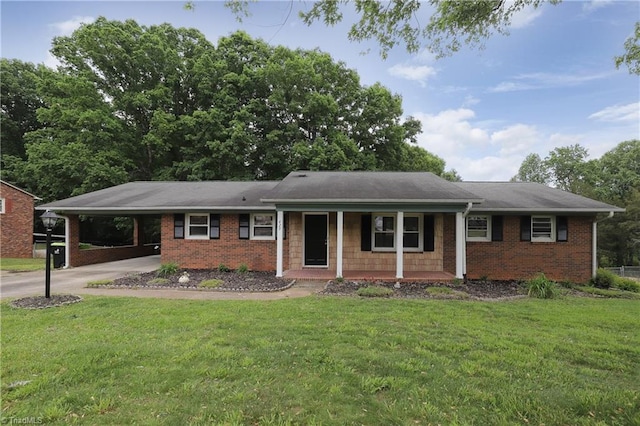 ranch-style house with covered porch, a carport, concrete driveway, a front lawn, and brick siding