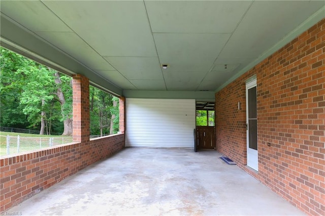 view of patio / terrace featuring an attached carport and fence