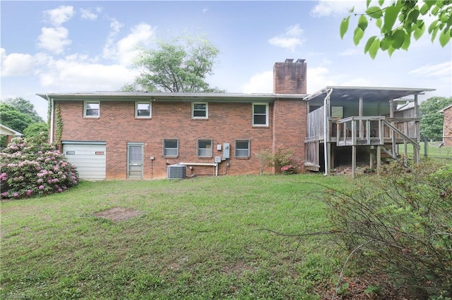 rear view of property featuring stairs, cooling unit, a chimney, and a lawn
