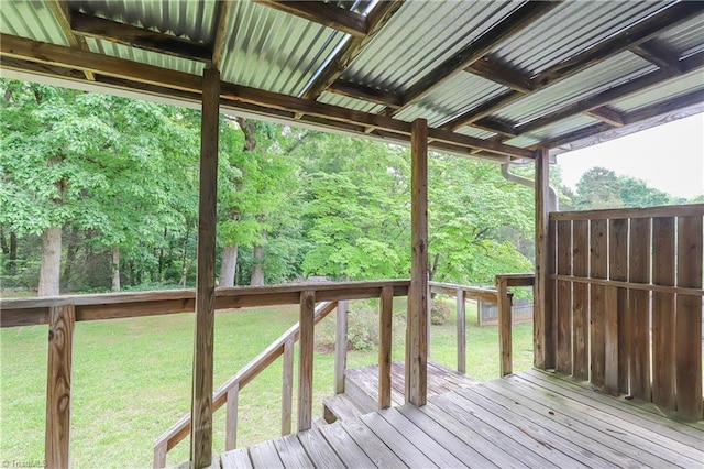 wooden terrace featuring a lawn