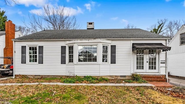 view of front of property featuring a front yard and french doors