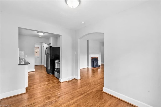 hall with hardwood / wood-style floors