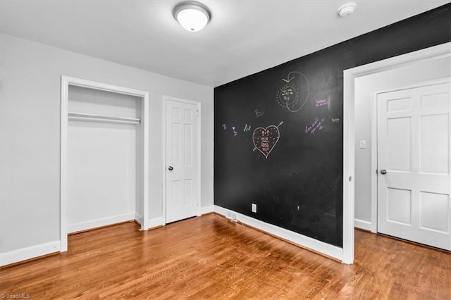 unfurnished bedroom featuring hardwood / wood-style flooring