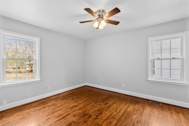 empty room featuring wood-type flooring and ceiling fan