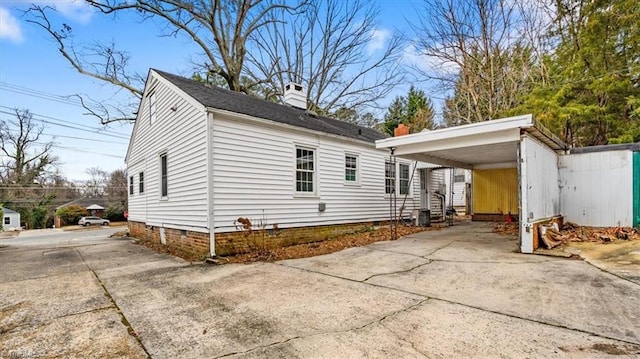 view of home's exterior featuring a carport