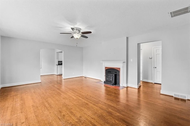 unfurnished living room featuring ceiling fan and wood-type flooring