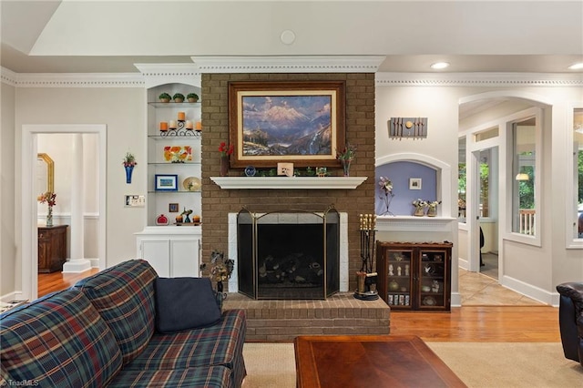 3805 Tangle Oak Dr, Clemmons, NC 27012 - living area with wood finished floors, built in shelves, a brick fireplace, and recessed lighting