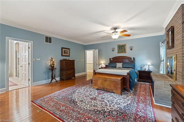 3805 Tangle Oak Dr, Clemmons, NC 27012 - bedroom featuring a fireplace, wood finished floors, crown molding, and a ceiling fan