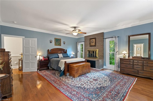 3805 Tangle Oak Dr, Clemmons, NC 27012 - bedroom featuring wood finished floors, a fireplace, ornamental molding, and ceiling fan